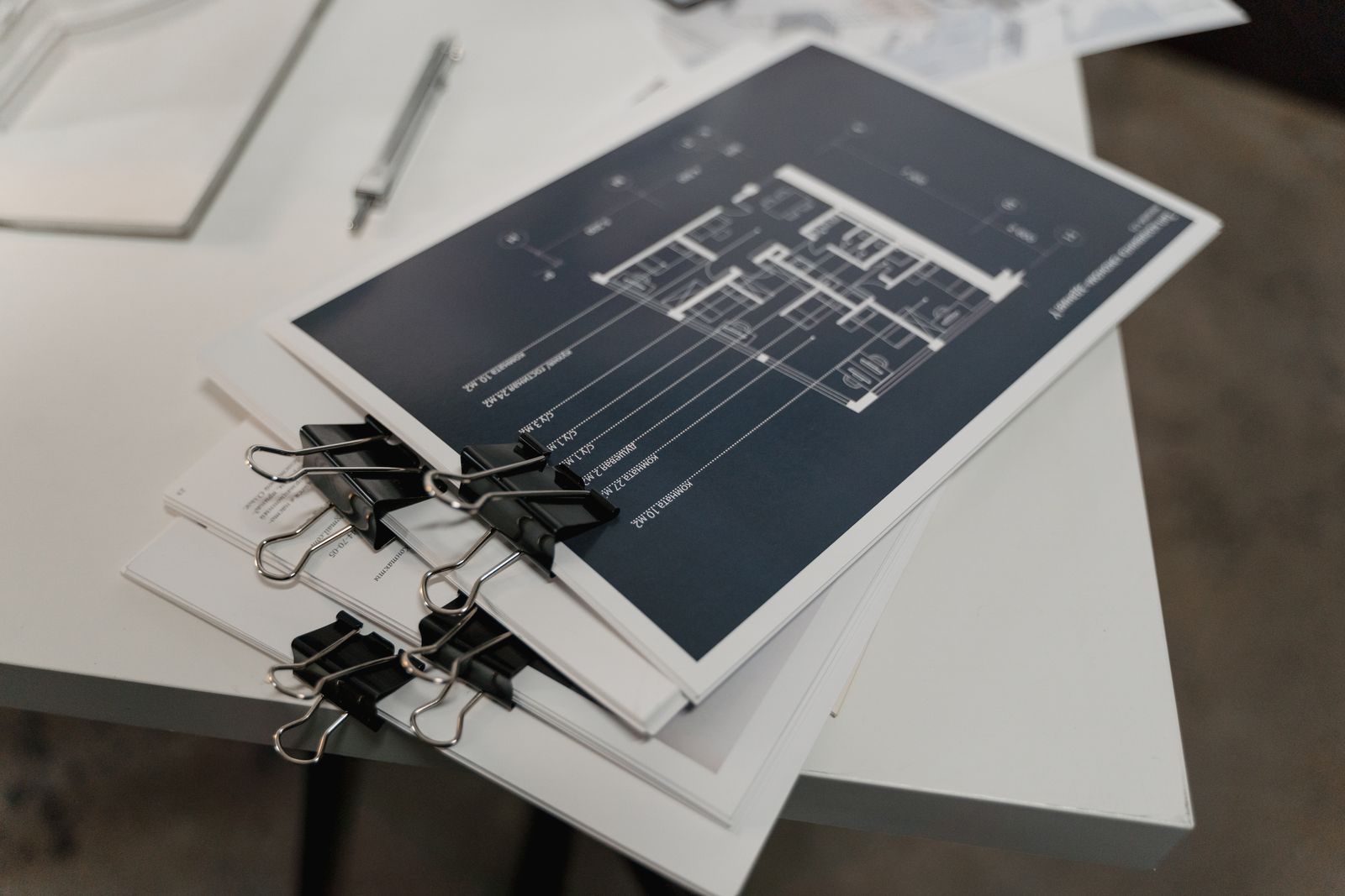 Stack of scale kitchen floor plans on a studio table